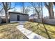 The backyard offers a tranquil setting with a modern shed and manicured lawn at 1603 Nowland Ave, Indianapolis, IN 46201