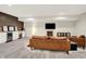 Basement entertainment area offers cozy seating, a fireplace, and a bar area with wine coolers at 1603 Nowland Ave, Indianapolis, IN 46201