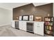 The finished basement features a bar area with a wine fridge, cabinets, and stylish decor at 1603 Nowland Ave, Indianapolis, IN 46201