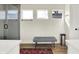 Bright bathroom space with modern bench, vanity and glass enclosed shower at 1603 Nowland Ave, Indianapolis, IN 46201