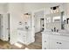 Bright bathroom featuring double vanities, modern lighting, quartz countertop, and wood look flooring at 1603 Nowland Ave, Indianapolis, IN 46201
