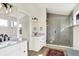 Modern bathroom featuring a spacious glass enclosed shower, double vanities, and contemporary finishes at 1603 Nowland Ave, Indianapolis, IN 46201