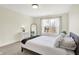Well lit bedroom with carpeted floors, a queen bed, and large window with natural light at 1603 Nowland Ave, Indianapolis, IN 46201