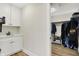 Open closet with white cabinets, sink, and clothing racks at 1603 Nowland Ave, Indianapolis, IN 46201