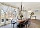 Well-lit dining area with large windows, offering a view of the outdoors and a contemporary lighting fixture at 1603 Nowland Ave, Indianapolis, IN 46201