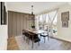 Bright dining room featuring modern light fixture, large windows with sheer curtains, and stylish decor at 1603 Nowland Ave, Indianapolis, IN 46201