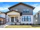 Charming two-story home featuring a modern design, covered front porch, and gray and white color scheme at 1603 Nowland Ave, Indianapolis, IN 46201