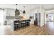 Modern kitchen with white cabinets, gray island with bar seating, and stainless steel appliances at 1603 Nowland Ave, Indianapolis, IN 46201