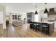Open-concept kitchen with an island with seating, seamlessly flowing into the cozy living room with fireplace at 1603 Nowland Ave, Indianapolis, IN 46201