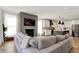 Comfortable living room with fireplace, large sectional sofa, and a view of the modern kitchen at 1603 Nowland Ave, Indianapolis, IN 46201