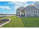 Beautiful backyard with lush lawn, leading to a scenic lake view and featuring a cozy patio area at 20834 Waterscape Way, Noblesville, IN 46062
