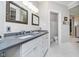 Bathroom features double sink vanity with gray countertop, neutral walls, and modern lighting at 20834 Waterscape Way, Noblesville, IN 46062