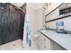 Modern bathroom featuring a sleek shower with dark tile and a floating vanity with quartz countertop at 20834 Waterscape Way, Noblesville, IN 46062