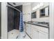 Modern bathroom features double sinks, black accent wall in shower, and neutral decor at 20834 Waterscape Way, Noblesville, IN 46062