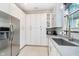 Bright kitchen features white cabinets, stainless steel refrigerator, microwave, and modern fixtures at 20834 Waterscape Way, Noblesville, IN 46062