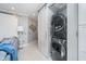 Convenient laundry area with a stackable washer and dryer, complete with a modern sliding barn door at 20834 Waterscape Way, Noblesville, IN 46062