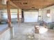 Spacious unfinished basement with a large door, window, workbench and concrete floor at 210 Evergreen St, Morgantown, IN 46160