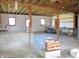 Unfinished basement with multiple windows, workbench and block pillar at 210 Evergreen St, Morgantown, IN 46160