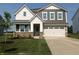 Charming two-story home featuring a two-car garage, brick accents, and well-manicured lawn, offering curb appeal at 2218 Boxwood Dr, Greenfield, IN 46140