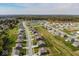 Aerial view of a residential neighborhood with tree-lined streets and a pond at 2268 Oakmont Dr, Plainfield, IN 46168