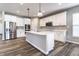 Modern kitchen featuring stainless steel appliances, white cabinets, a central island, and pendant lighting at 2352 Somerset Cir, Franklin, IN 46131