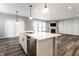 Modern kitchen featuring stainless steel appliances, white cabinets, a central island, and pendant lighting at 2352 Somerset Cir, Franklin, IN 46131