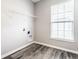 Laundry room with wood-look floors, window and shelving at 2352 Somerset Cir, Franklin, IN 46131