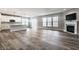 Bright living area with a fireplace, wood-look floors, and a partial view of the modern kitchen at 2352 Somerset Cir, Franklin, IN 46131