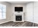 Cozy living room featuring a fireplace with white mantel, wood-look flooring, and a wall of decorative molding at 2352 Somerset Cir, Franklin, IN 46131