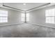 Spacious main bedroom with plush carpet, tray ceiling, and multiple windows with blinds at 2352 Somerset Cir, Franklin, IN 46131