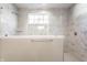 Marble tiled shower with a glass enclosure and chrome fixtures at 2352 Somerset Cir, Franklin, IN 46131