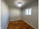 Well-lit bedroom featuring hardwood floors, neutral paint, a modern ceiling light, and a window at 238 N 7Th Ave, Beech Grove, IN 46107