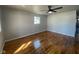 Spacious bedroom with polished hardwood floors, neutral color scheme, modern ceiling fan, and natural light at 238 N 7Th Ave, Beech Grove, IN 46107