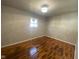 Cozy bedroom with gleaming hardwood floors, neutral paint, modern lighting, and great natural light at 238 N 7Th Ave, Beech Grove, IN 46107