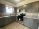 A kitchen with gray cabinets, stone countertops, and stainless steel oven appliance at 238 N 7Th Ave, Beech Grove, IN 46107