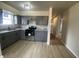 A kitchen featuring gray cabinets, stone countertops, stainless steel appliances, and light wood-look flooring at 238 N 7Th Ave, Beech Grove, IN 46107