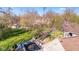 Aerial view of the property showcasing a large backyard, mature trees, detached garage, and roof at 241 Melissa Ann Ct, Indianapolis, IN 46234
