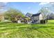 Expansive backyard featuring a in-ground pool, stone retaining walls, and mature trees and landscaping at 241 Melissa Ann Ct, Indianapolis, IN 46234