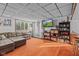 Cozy finished basement features a large sectional, an entertainment center, and an access door to the outside at 241 Melissa Ann Ct, Indianapolis, IN 46234