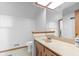 Bathroom featuring a cream vanity top, mirror, skylight, and adjacent toilet space at 241 Melissa Ann Ct, Indianapolis, IN 46234
