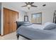 Cozy bedroom features a ceiling fan, closet, and a window for natural light at 241 Melissa Ann Ct, Indianapolis, IN 46234