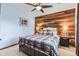 Beautiful bedroom features a wood accent wall with a comfortable bed and warm decor at 241 Melissa Ann Ct, Indianapolis, IN 46234