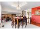 Spacious dining area with stone fireplace, stylish lighting, and an open layout to the entryway at 241 Melissa Ann Ct, Indianapolis, IN 46234