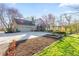 Charming home featuring a stone exterior, attached garage, garden beds, and a second story outdoor patio at 241 Melissa Ann Ct, Indianapolis, IN 46234