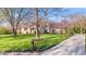 Charming stone-clad home boasts a well-manicured lawn and long driveway at 241 Melissa Ann Ct, Indianapolis, IN 46234