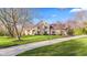 Stunning stone home with a manicured lawn and long driveway, showcasing curb appeal at 241 Melissa Ann Ct, Indianapolis, IN 46234