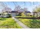 Beautiful home featuring a stone exterior, two-car garage, and a meticulously landscaped front yard with a stone pathway at 241 Melissa Ann Ct, Indianapolis, IN 46234