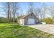 Detached garage with stone accents, surrounded by a large grassy yard with mature trees at 241 Melissa Ann Ct, Indianapolis, IN 46234