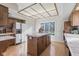 Updated kitchen showcases an island, white appliances, tile countertops and wooden cabinetry at 241 Melissa Ann Ct, Indianapolis, IN 46234