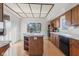 Bright kitchen features a center island, white appliances, tile countertops and wooden cabinetry at 241 Melissa Ann Ct, Indianapolis, IN 46234